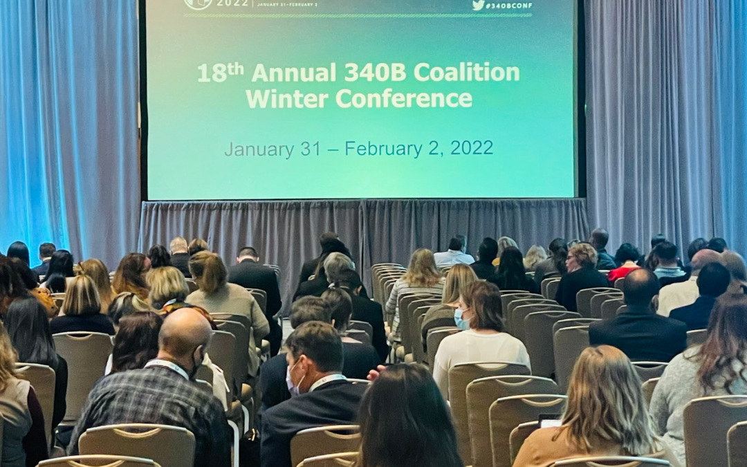 People sitting in a room with a project screen at 2022 340B Coalition Winter Conference